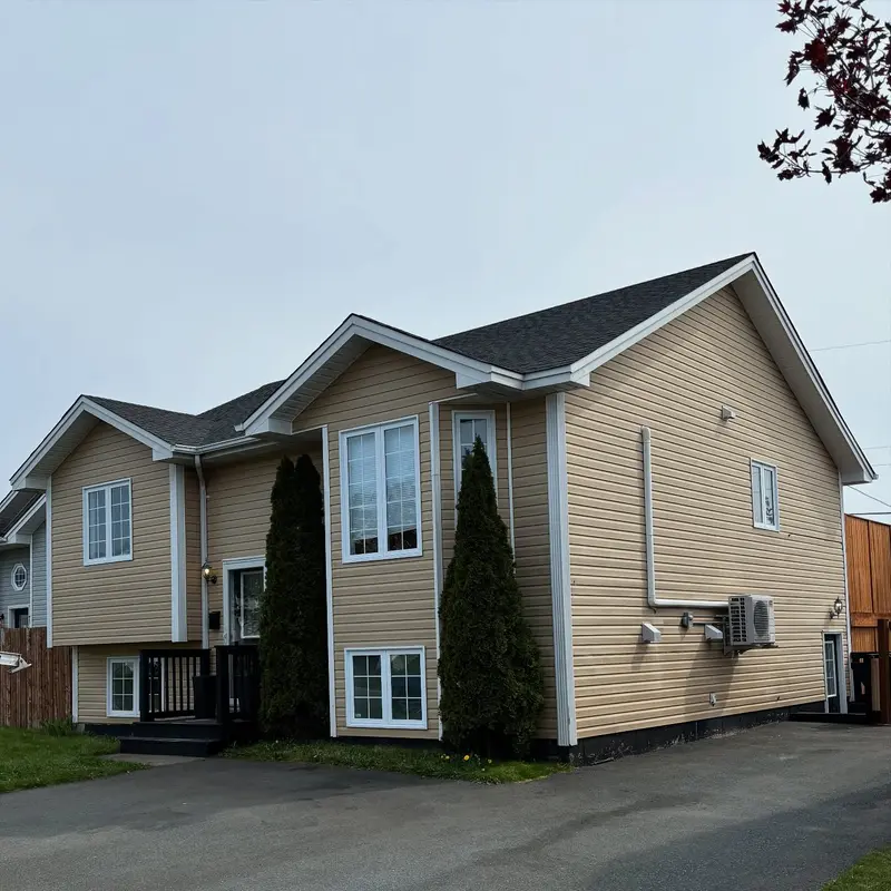 Beige split-level house with a new grey shingled roof